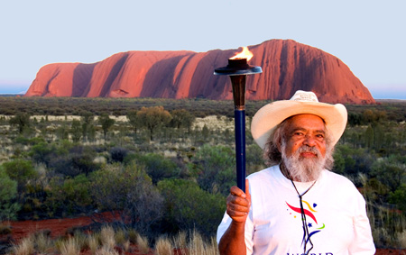 Bob Randall holds the World Harmony Run torch at Ulura, 2008