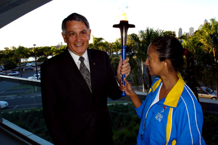 Ron Clarke and Kapila Moses holding the World Harmony Run torch in 2005