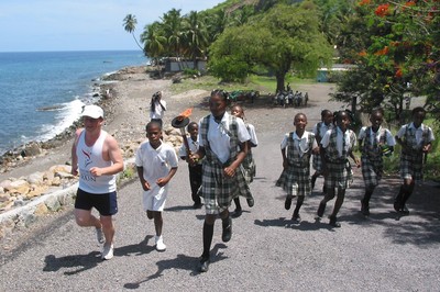 Dominica school children run by the coast
