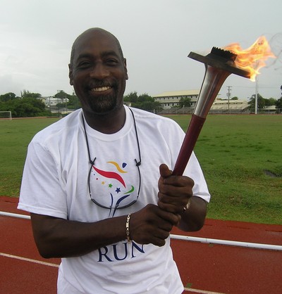 Sir Vivian Richards, Antigua & Barbuda, (close) holds torch