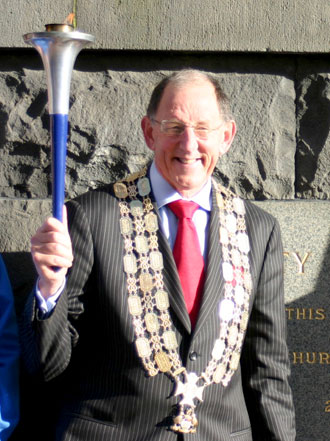 The Mayor of Auckland, Dick Hubbard holds the World Harmony Run torch