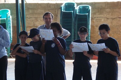 Deputy Head of HOPAC’s Secondary division Mr Richard Feather with pupils studying the WHR Song.