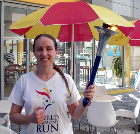 Kylie Williams holds the World Harmony Run torch