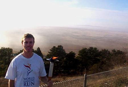 Nigel Webber holds the World Harmony Run torch at Lake George Nigel Webber holds the World Harmony Run torch at Lake George