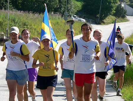 Sandro Zincarini running with the World Harmony Run torch