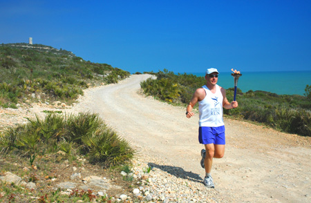 Standa Zubaty running by the sea in the World Harmony Run