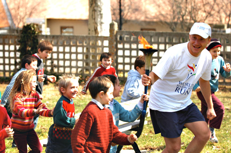 Standa Zubaty runs with children in the World Harmony Run