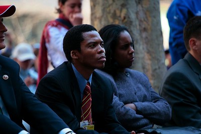 The audience listens.