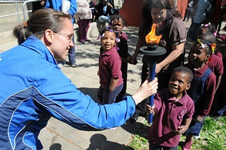 Phil Montesori Children hold torch and give joy