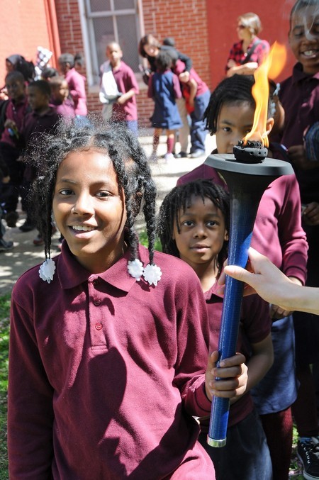 Phil Montessouri School 3 girls hold torch